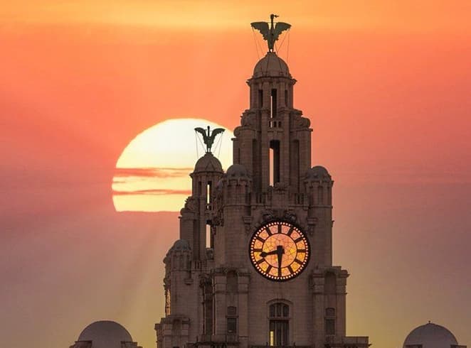 liverpool royal liver building at sunset near a church in Liverpool landmark view